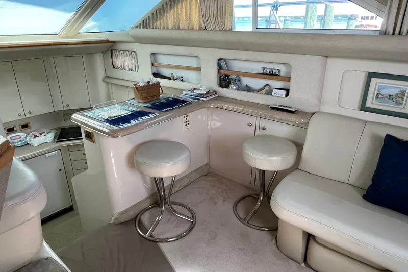 Slide: The Image of Luxurious interior of 1997 Sea Ray 420 Aft Cabin yacht with seating and bar area. - 25