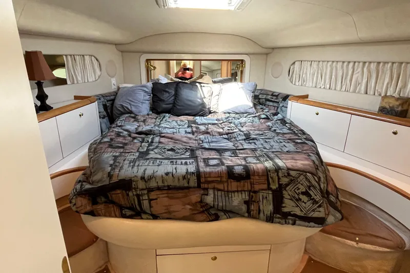 Slide: The Image of Cozy bedroom in 1997 Sea Ray 420 Aft Cabin yacht with patterned bedding. - 33
