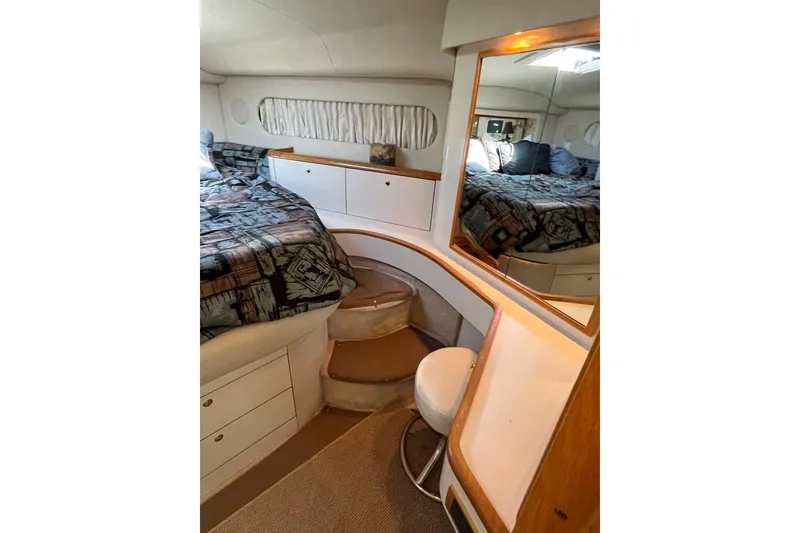Slide: The Image of Luxurious 1997 Sea Ray 420 Aft Cabin interior with cozy bed and elegant furnishings. - 34