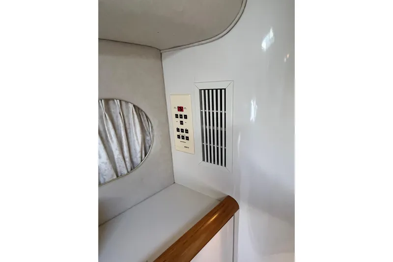 Slide: The Image of 1997 Sea Ray 420 Aft Cabin interior with control panel and vent. - 35
