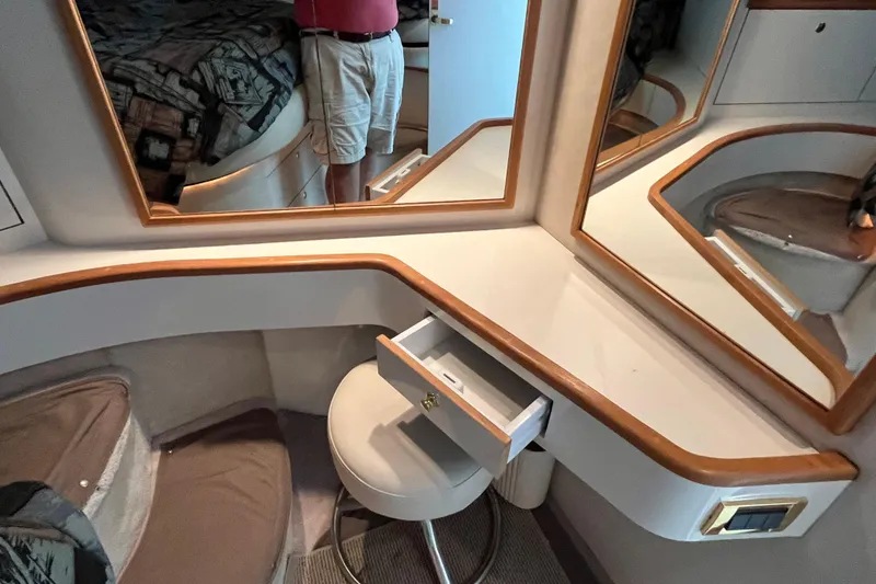 Slide: The Image of 1997 Sea Ray 420 Aft Cabin interior with vanity, mirrors, and seating. - 36