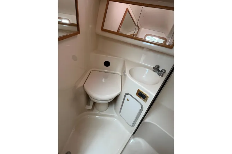 Slide: The Image of 1997 Sea Ray 420 Aft Cabin bathroom with toilet, sink, and mirror. - 37
