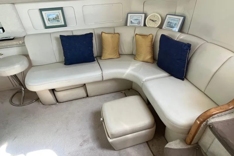 Slide: The Image of Luxurious 1997 Sea Ray 420 Aft Cabin interior with plush seating and decorative pillows. - 39