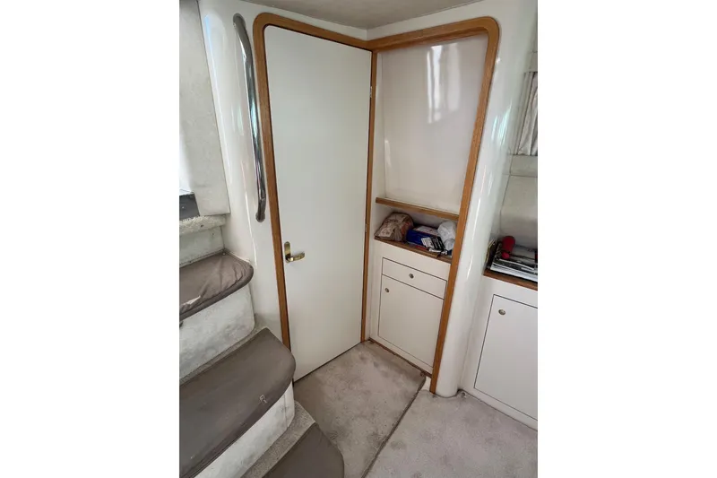 Slide: The Image of Interior of 1997 Sea Ray 420 Aft Cabin with stairs and storage cabinets. - 40