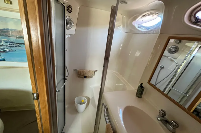 Slide: The Image of Bathroom interior of 1997 Sea Ray 420 Aft Cabin yacht, featuring shower and sink. - 49