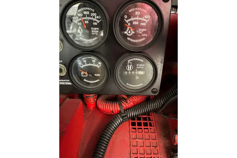 Slide: The Image of Instrument panel of a 1997 Sea Ray 420 Aft Cabin boat showing gauges and wiring. - 57