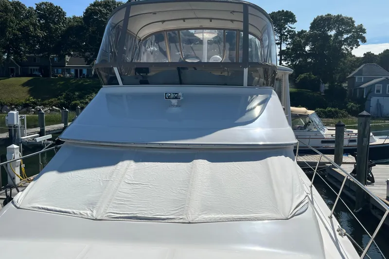 Slide: The Image of 1997 Sea Ray 420 Aft Cabin yacht docked at marina, sunny day. - 7
