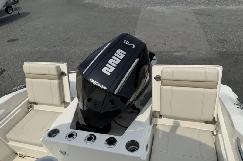 Slide: The Image of 2024 Boston Whaler 220 Dauntless boat with Mercury V6 engine and seating area. - 10