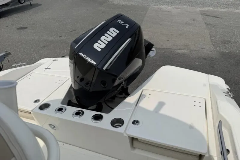 Slide: The Image of 2024 Boston Whaler 220 Dauntless boat with Mercury outboard engine, rear view. - 11