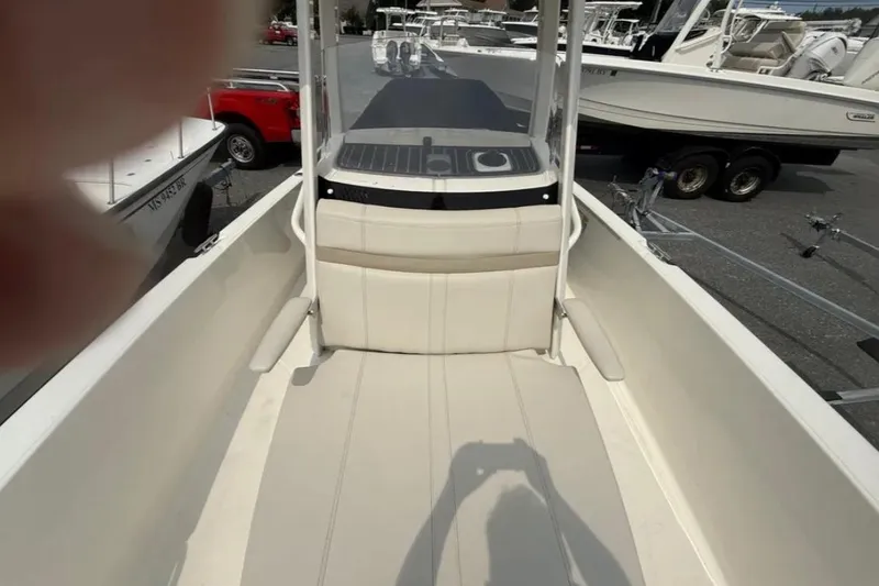 Slide: The Image of 2024 Boston Whaler 220 Dauntless boat interior with seating and console view. - 4