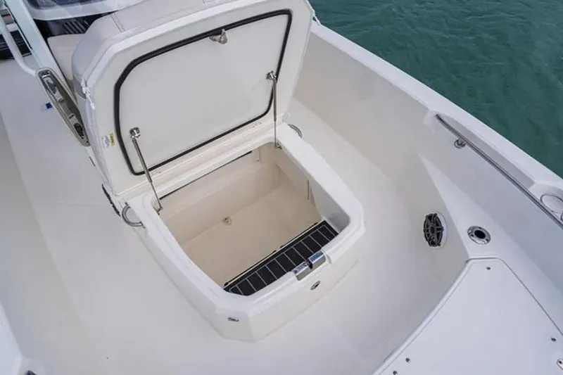 Slide: The Image of 2024 Boston Whaler 220 Dauntless boat storage compartment open, showcasing spacious interior. - 5