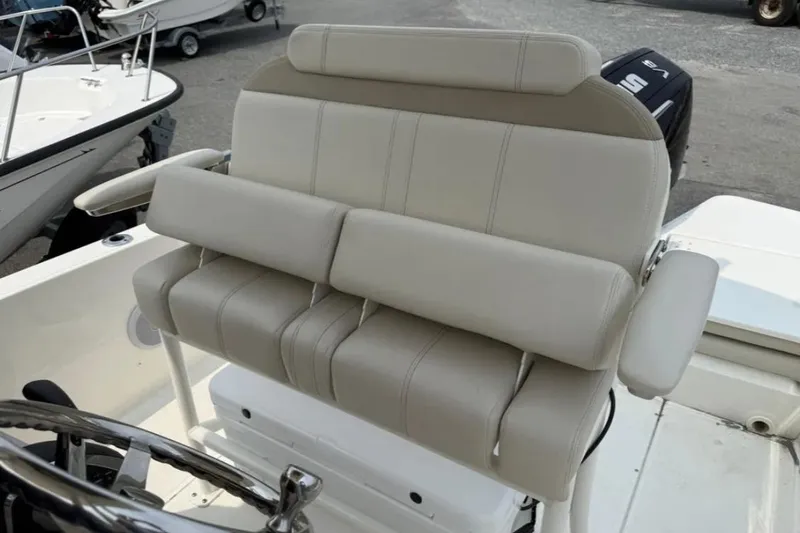 Slide: The Image of 2024 Boston Whaler 220 Dauntless boat seat with beige upholstery and armrests. - 7