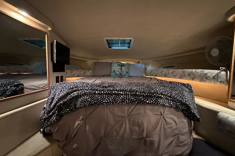 Slide: The Image of Cozy cabin interior of 1997 Sea Ray Sundancer 370 with bed and TV. - 22