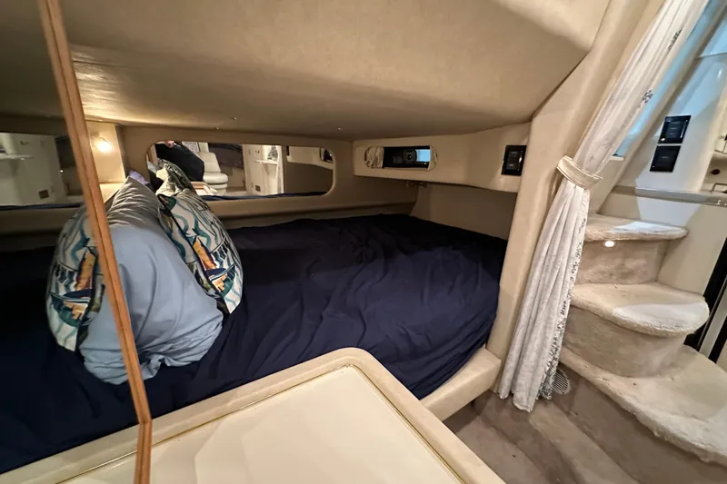 Slide: The Image of Cozy cabin interior of 1997 Sea Ray Sundancer 370 with bed and stairs. - 26