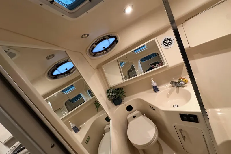 Slide: The Image of Bathroom interior of 1997 Sea Ray Sundancer 370 yacht, featuring sink and toilet. - 27
