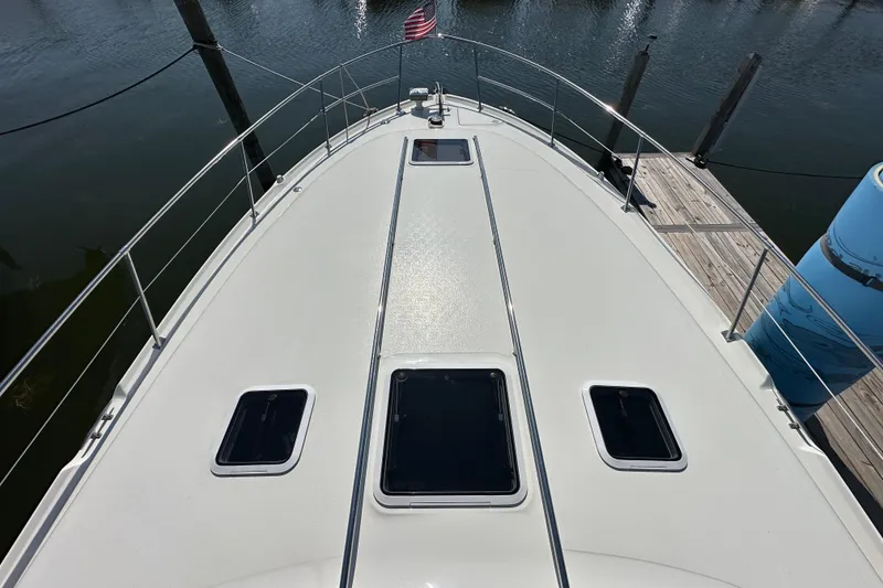 Slide: The Image of 1997 Sea Ray Sundancer 370 yacht deck with hatches, docked by the water. - 3