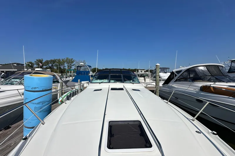 Slide: The Image of 1997 Sea Ray Sundancer 370 docked at marina under clear blue sky. - 5