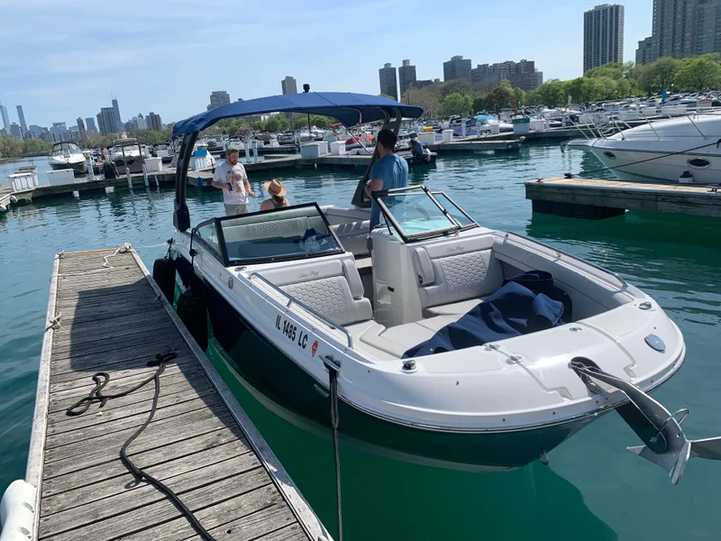 The Image of 2021 Sea Ray SDX 270 boat docked with city skyline view. - 0