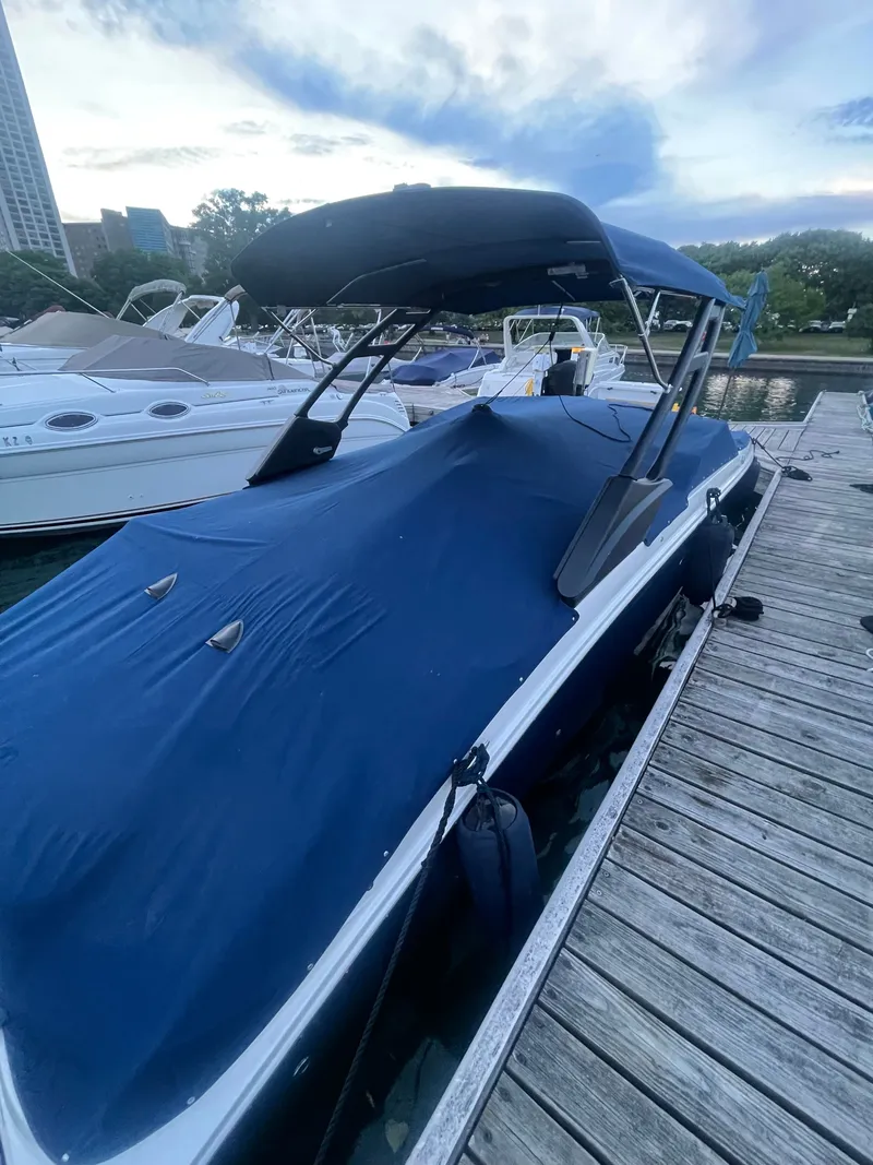 Slide: The Image of 2021 Sea Ray SDX 270 boat covered at dock. - 2