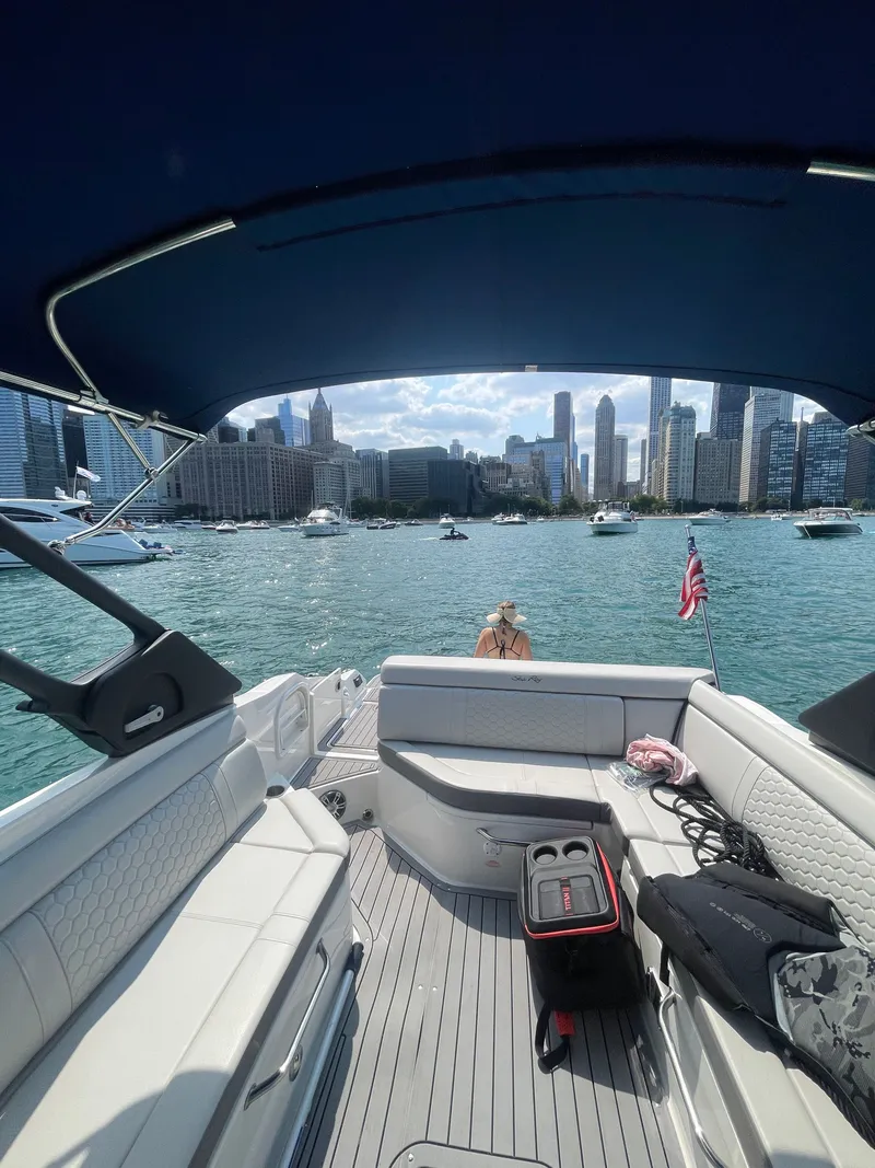 Slide: The Image of Sea Ray SDX 270 boat with city skyline in background. - 3