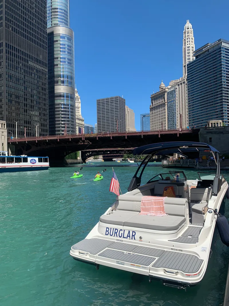 Slide: The Image of Sea Ray SDX 270 boat on a city river. - 5