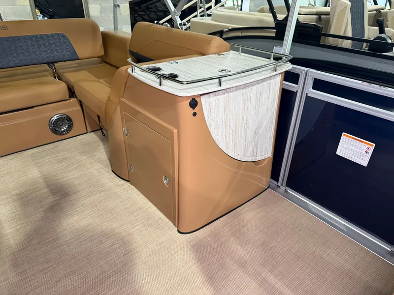 Slide: The Image of Interior of a 2026 Harris Solstice 250 with brown seating and a small table. - 26