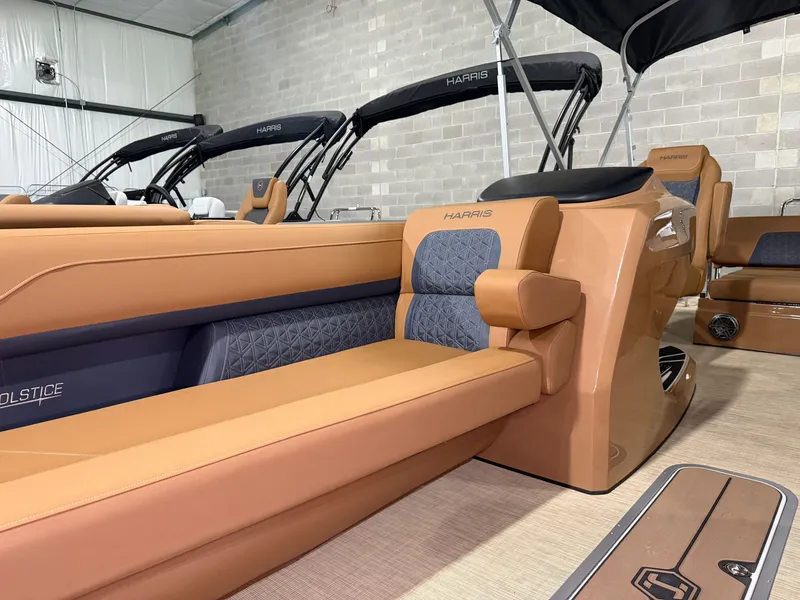 Slide: The Image of The image shows the interior of a Harris Solstice 250 boat with sleek, modern seating. - 17