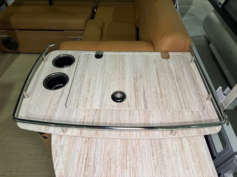 Slide: The Image of A sleek bar table with two cup holders and a glass edge on a Harris Solstice 250 boat. - 28