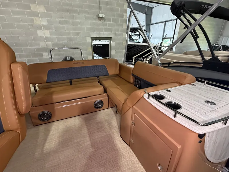 Slide: The Image of Interior of a Harris Solstice 250 with brown leather seating and a table with cup holders. - 45