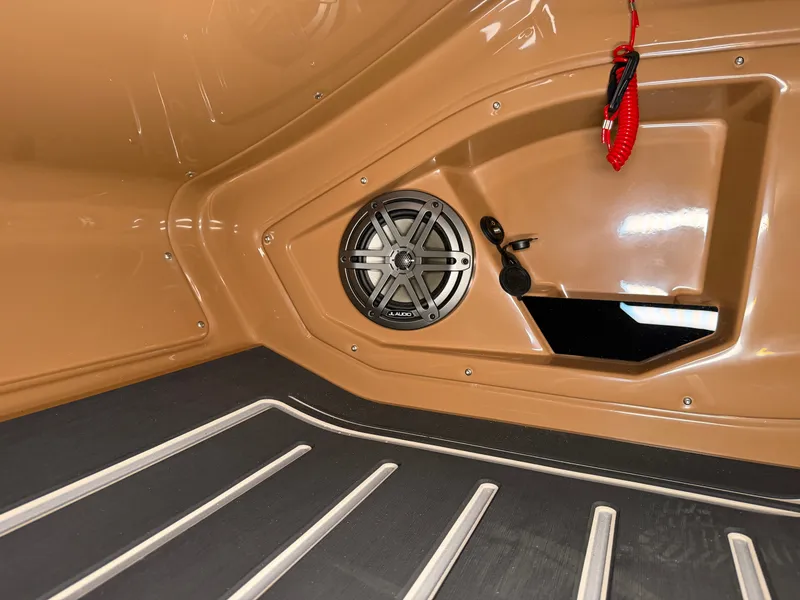 Slide: The Image of Close-up of a speaker in a boat with brown interior and black flooring. - 42