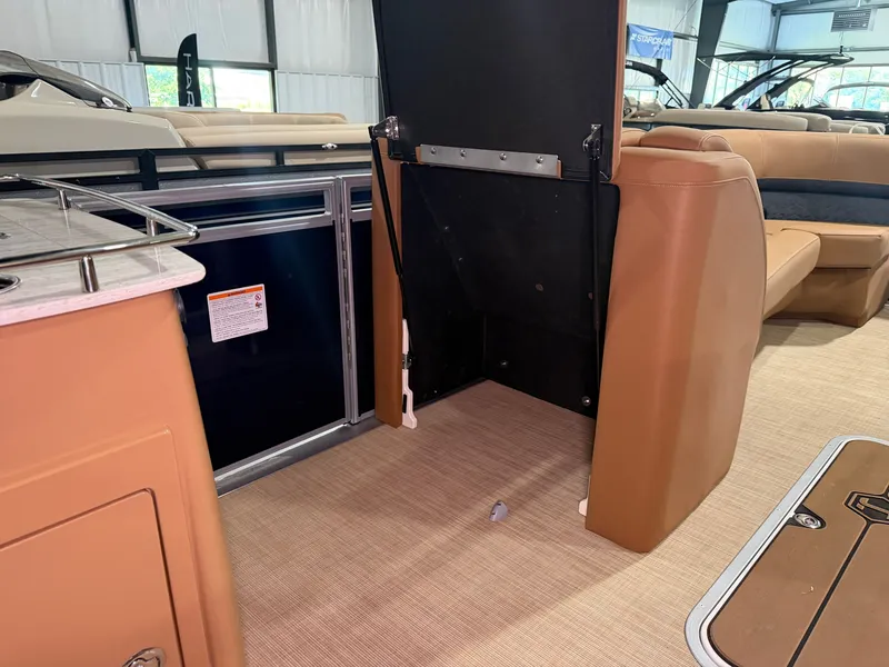 Slide: The Image of Interior of a 2026 Harris Solstice 250 with beige seating and carpeted flooring. - 33