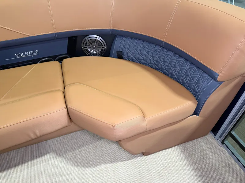 Slide: The Image of The 2026 Harris Solstice 250 features luxurious beige upholstery with blue accents and a speaker. - 19