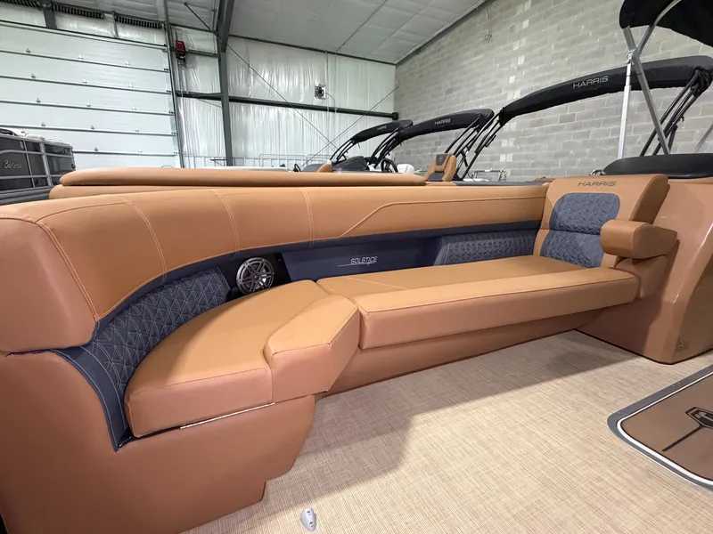 Slide: The Image of Interior of a 2026 Harris Solstice 250 with sleek, brown leather seating. - 15