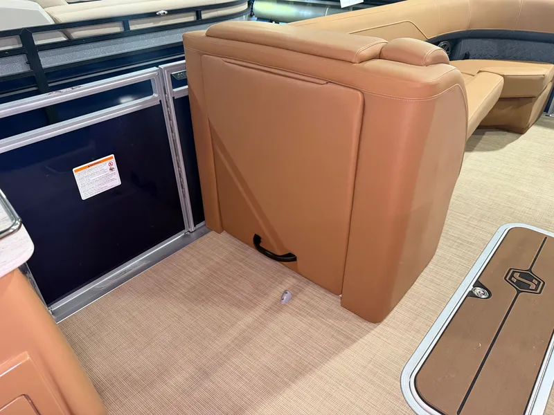 Slide: The Image of The image shows the interior of a Harris Solstice 250 boat with beige leather seating and carpeted floor. - 32