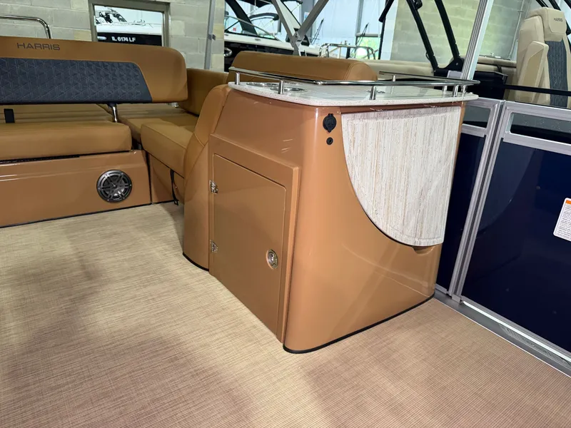 Slide: The Image of Interior of a 2026 Harris Solstice 250 with beige seating and a small cabinet. - 30