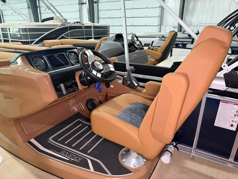 Slide: The Image of The image shows the cockpit of a 2026 Harris Solstice 250 with a beige captain's chair. - 35