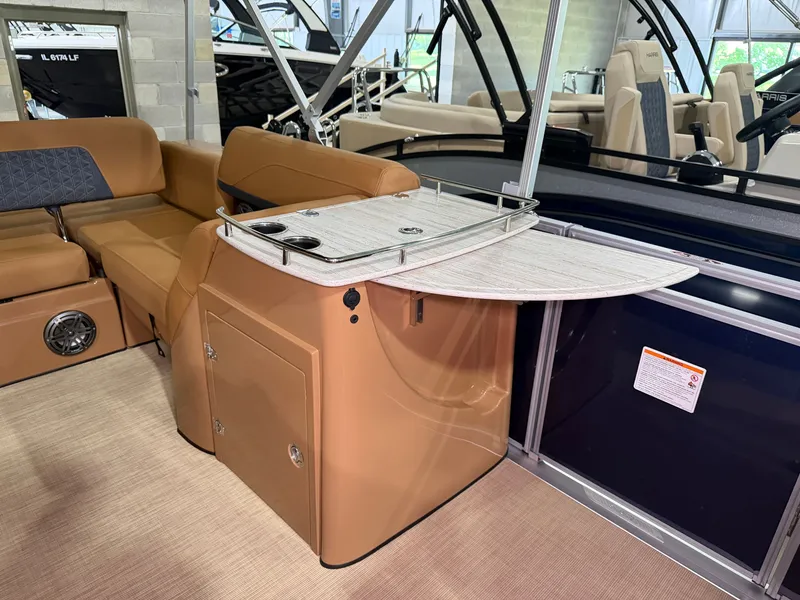 Slide: The Image of Interior of a 2026 Harris Solstice 250 with beige upholstery and a foldable table. - 27