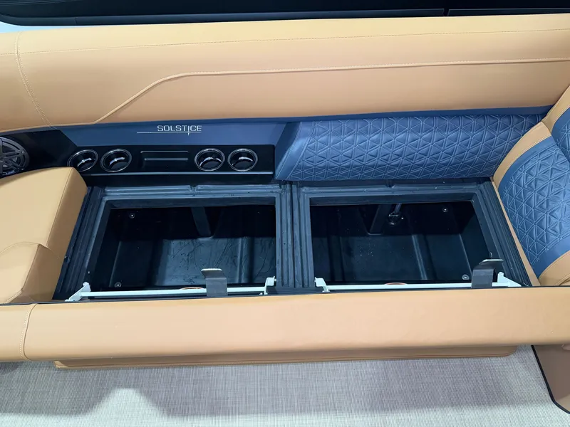 Slide: The Image of The 2026 Harris Solstice 250 features a sleek seating area with storage compartments underneath. - 14