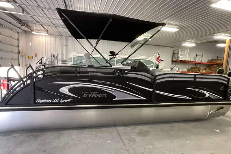 The Image of 2026 JC Neptoon Sport 21TT pontoon boat in a garage setting. - 1