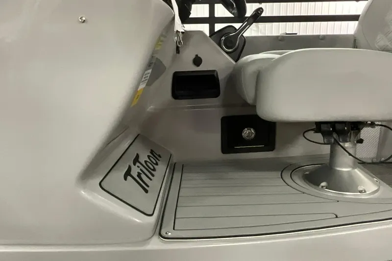 Slide: The Image of 2026 JC NEPTOON SPORT 21TT boat interior with steering and seating area. - 13