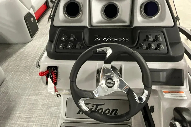Slide: The Image of 2026 JC NEPTOON SPORT 21TT boat dashboard with steering wheel and control panel. - 14