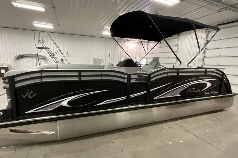 Slide: The Image of 2026 JC NEPTOON SPORT 21TT pontoon boat in a garage, featuring sleek black design and canopy. - 3