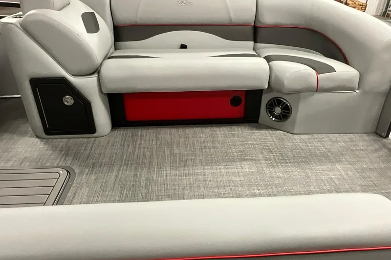 Slide: The Image of 2026 JC NEPTOON SPORT 21TT boat interior with gray seating and red accents. - 8