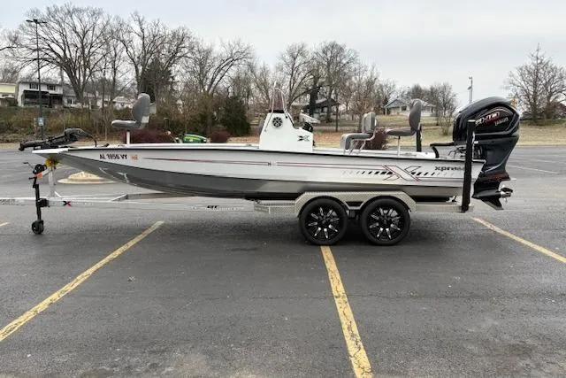 Slide: The Image of 2024 Express H22B boat on trailer in parking lot, side view. - 1
