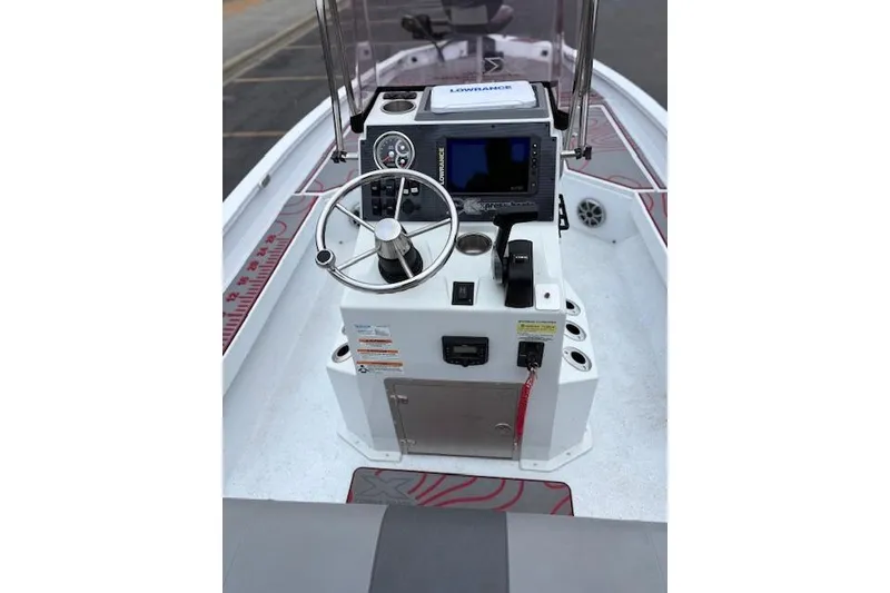 Slide: The Image of 2024 Express H22B boat console with steering wheel and navigation equipment. - 14