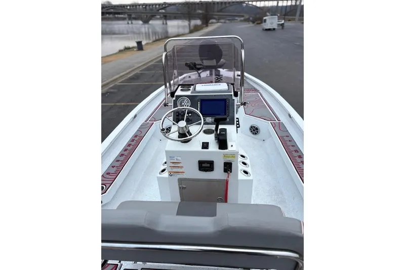 Slide: The Image of 2024 Express H22B boat dashboard with steering wheel and navigation system. - 15