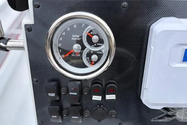 Slide: The Image of 2024 Express H22B dashboard with RPM gauge, switches, and controls. - 18