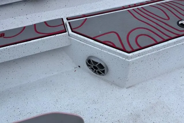 Slide: The Image of 2024 Express H22B boat deck with red-patterned design and speaker detail. - 24