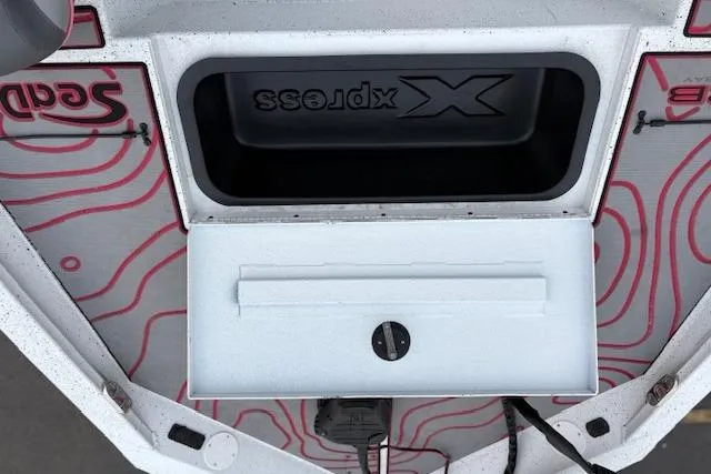 Slide: The Image of 2024 Express H22B boat storage compartment with red pattern design and secure latch. - 26