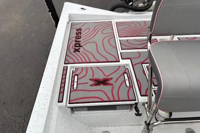 Slide: The Image of 2024 Express H22B boat deck with custom red and gray design, featuring seating and storage. - 34